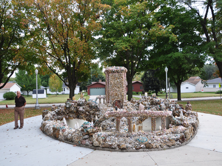 Lee Duquette and  a waterless fountain in front of the Church,.