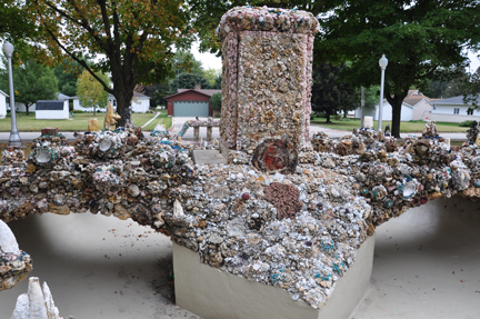 a waterless fountain in front of the Church,.