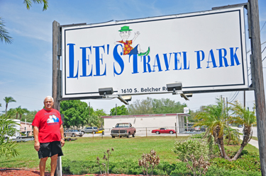 Lee Duquette at the Lee's Travel Park Sign