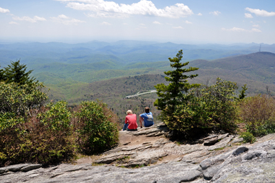 people sitting on the edge of the cliff