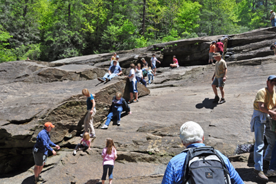 people slidding down the rocks