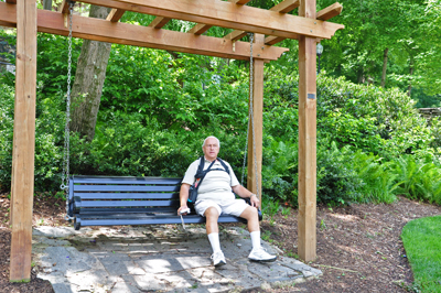 Lee Duquette resting on a swinging bench