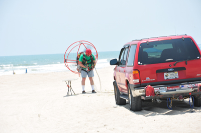 a man getting geared up in his powered parachute