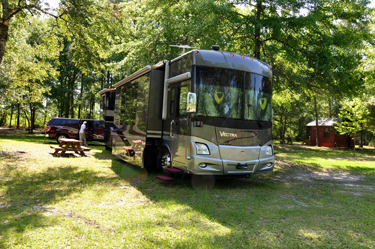 the RV of the two RV Gypsies in its new yard