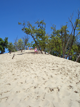 Karen is almost to the top of the sand dune