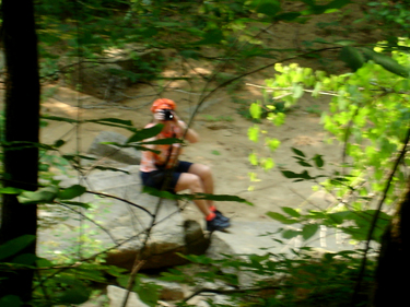 Karen Duquette taking pictures of Lee and Alex in the woods.