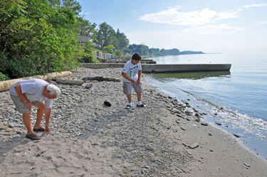 Lee Duquette and his grandson skip rocks into Lake Erie