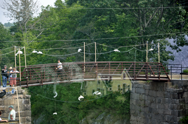 This bridge is decorated with fish hanging from it.