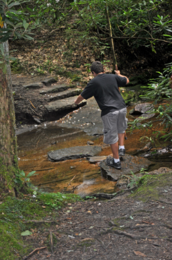 the grandson of the two RV Gypsies crossing a stream