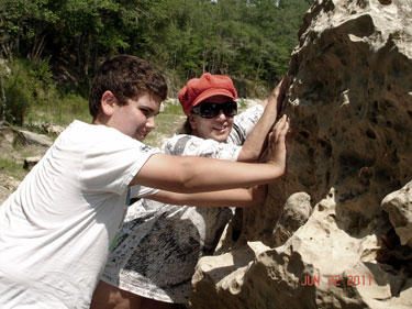 Alex and Karen try to move the big rock