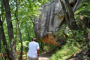 the grandson of the two RV Gypsies at a large rock overhang 