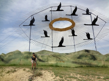 Karen Duquette standing  by the Geese in Flight Sculpture