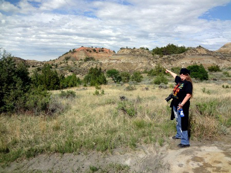 Karen Duquette pointing to famous rock formation at the Painted Canyon