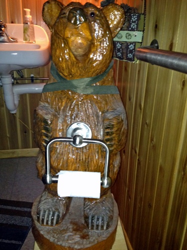 carved bear toilet paper holder  in the restroom at Lemon Wolf Cafe