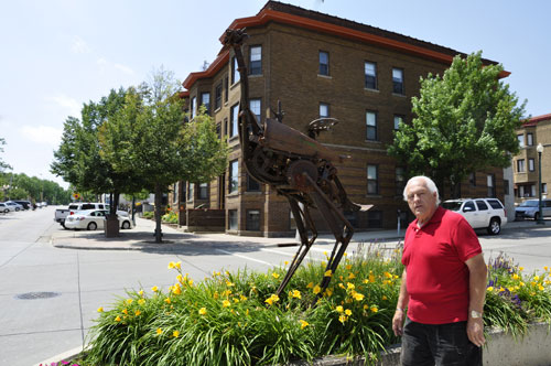 Lee Duquette by the Implement Bird sculpture