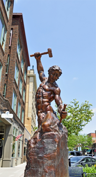 Self Made Man sculpture - a man carving himself