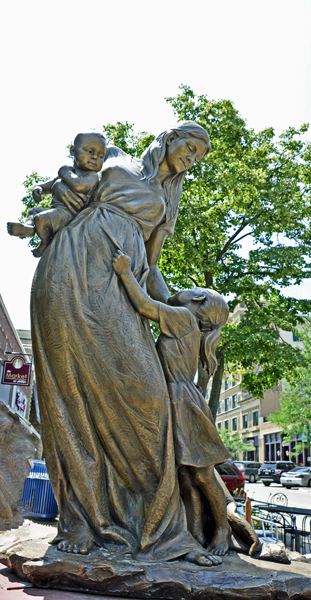 Mother's Undivided Love sculpture - a mother with two children