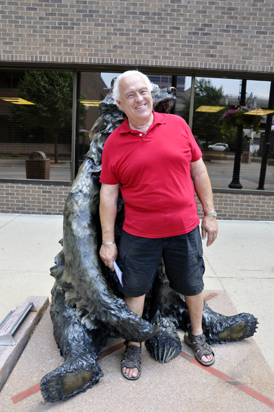 Lee Duquette with the grizzly bear sculpture