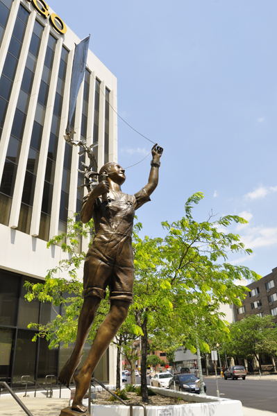 person flying a kite sculpture