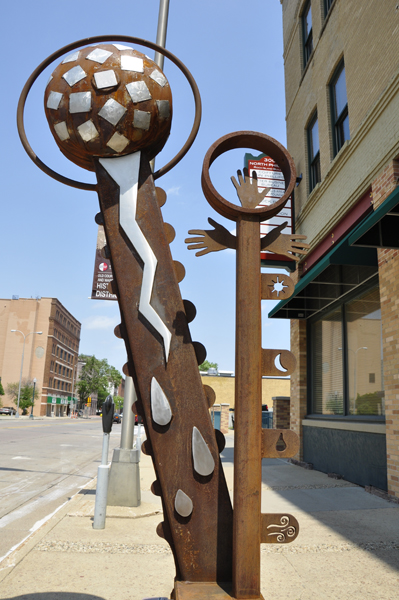 hands and a globe sculpture