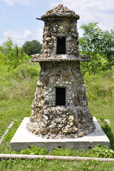 a double birdhouse almost shaped like a lighthouse