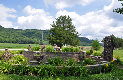 a circle of flowers and statues