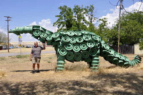 Lee Duquette by the tire rim dinosaur