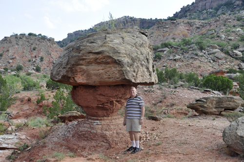 Lee Duquette at a fragile balanced rock deep on the floor of the Palo Duro Canyon