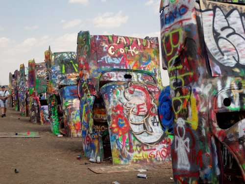 Brightly-painted Cadillacs, all in a row at Cadillac Ranch in Texas