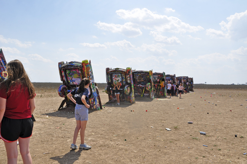 Brightly-painted Cadillacs, all in a row at Cadillac Ranch in Texas