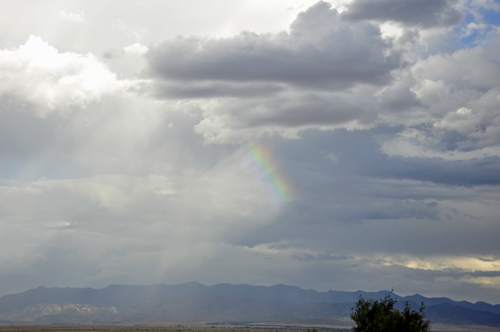 a small piece of a rainbow in the sky.