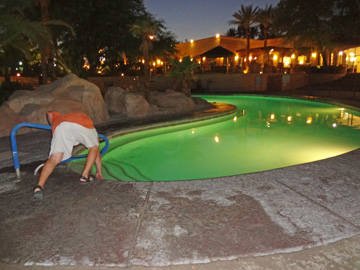 Lee Duquette checking the temperature of the adult pool