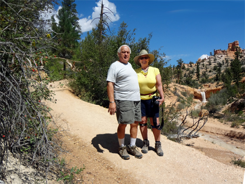 the two RV Gypsies are enjoying the view of the small waterfall.