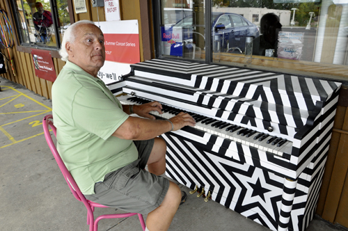 Lee Duquette entertains on a piano