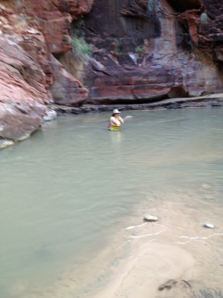 Karen Duquette in waist-deep water in the Virgin River at Zion National Park