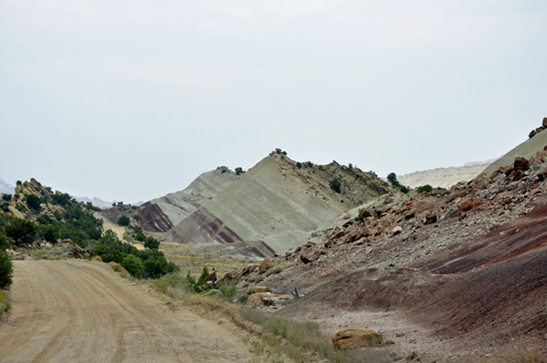 a hill with red dirt and white stripes.