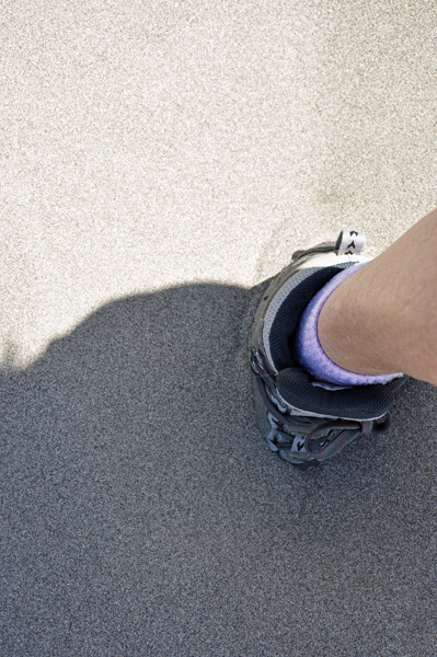 Karen Duquette's foot sinking into the sand