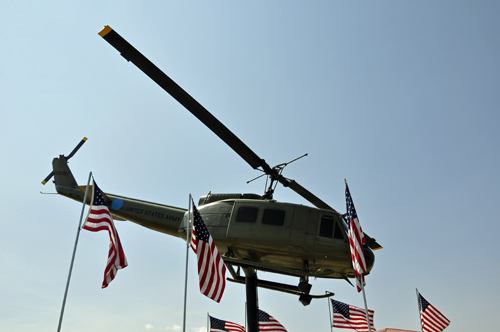 a UH-1H Huey helicopter and USA flags