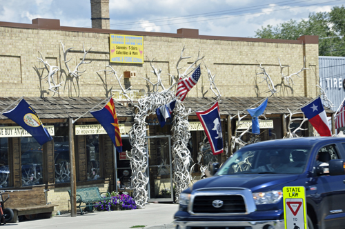 The doorway of a store - with tons of antlers