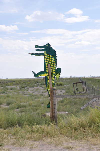 a rocking gator on a post