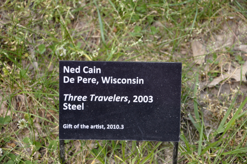sign about the art sculpture Three Travelers