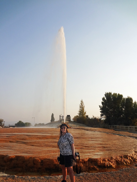 Karen Duquette in front of the 100fot geyser eruption