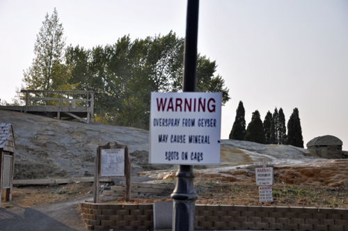 Warning sign not to park car too close to the geyser