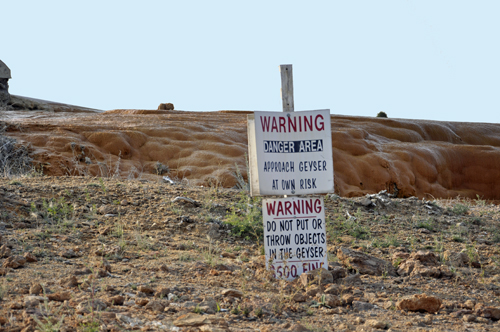 Warning sign not to park car too close to the geyser