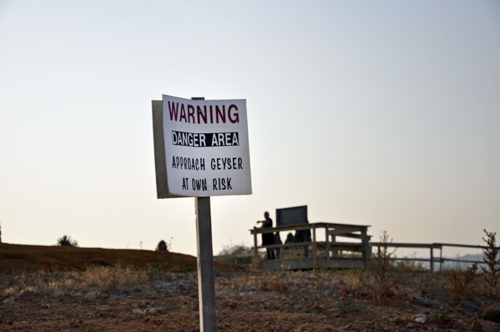 Warning sign not to park car too close to the geyser