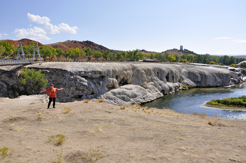 Karen Duquette beside the suspension bridge and Rainbow Terrace