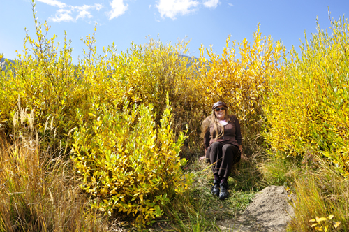 Karen Duquette sitting in the fall foliage