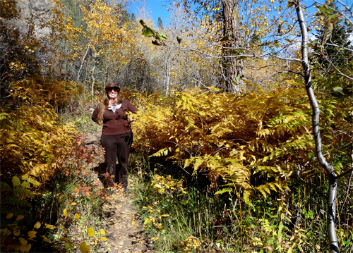 Karen Duquette by large, colorful ferns