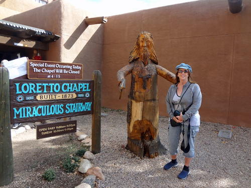 Karen Duquette by the Loretto Chapel sign