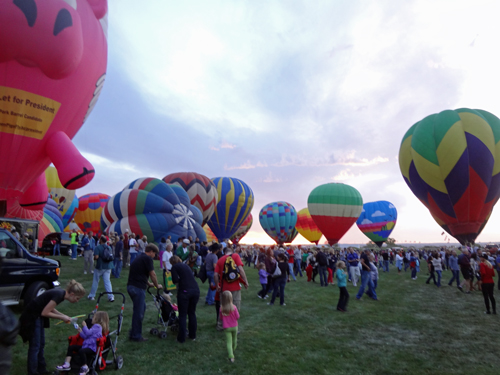 hot air balloons and many people